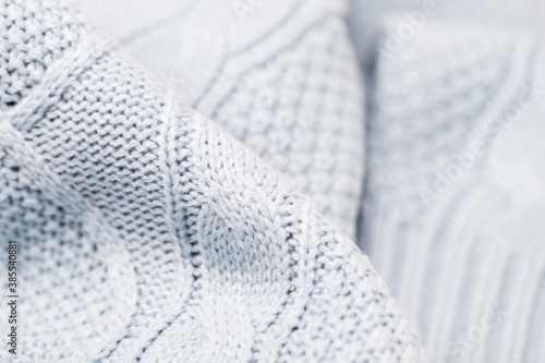 Light blue gray fabric background. Full frame shot of knitted fabric