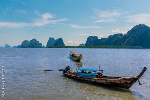 Longtailed speed boats moored off the settlement and island of Ko Panyi in Phang Nga Bay, Thailand