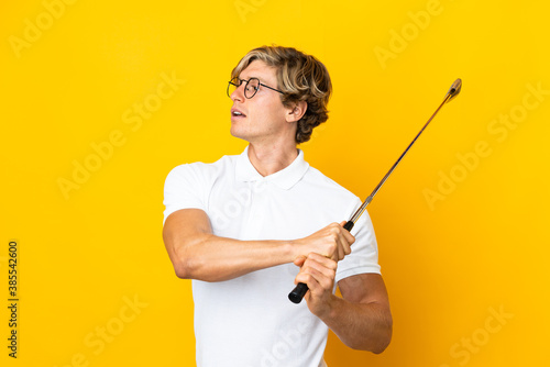 English man over isolated white background playing golf