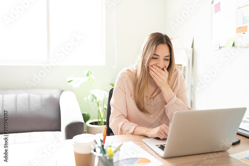 Cute woman giggling at the office