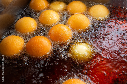 Buñuelos in hot oil cooking - typical Colombian food