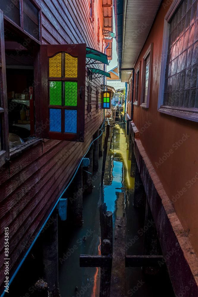Fototapeta premium Narrow waterways separate house on the settlement built on stilts of Ko Panyi in Phang Nga Bay, Thailand