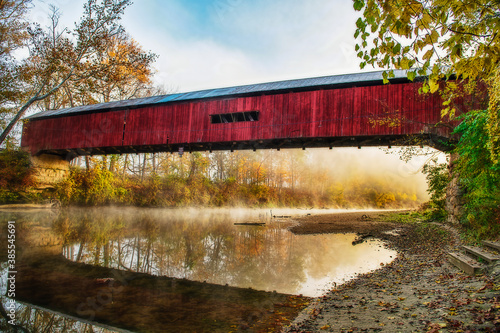 Cox Ford Covered Bridge in Rural Indiana. This is a working bridge on a public road. The picture was taken in the early morning with fog on the creek. photo