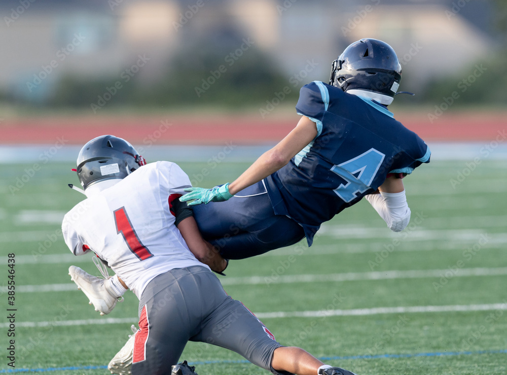 Amazing athletes making great catches and runs during a competitive football game Amazing athletes making great catches and runs during a competitive football game