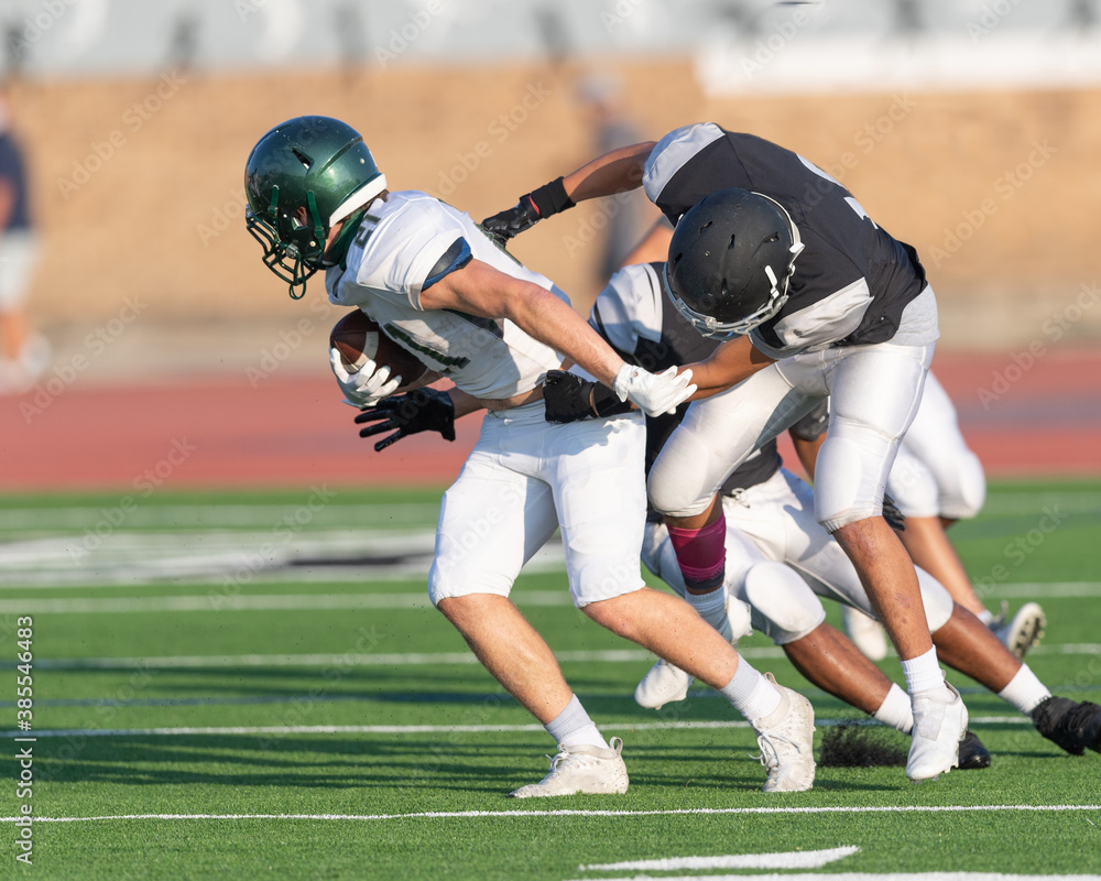 Amazing athletes making great catches and runs during a competitive football game Amazing athletes making great catches and runs during a competitive football game