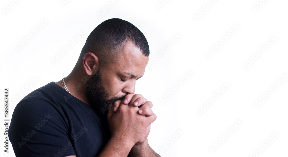 Brazilian home, brunette, black shirt, praying, white background, hands, feeling, faith, worship, sad, hopeful, during the pandemic. Brazilian home, brunette, black shirt, praying, white background, hands, feeling, faith, worship, sad, hopeful, during the pandemic.