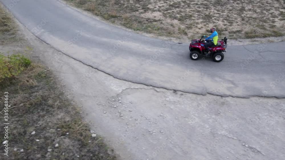 Men on quad bikes and racing motorcycle ride on a road. Men on quad bikes and racing motorcycle ride on a road.