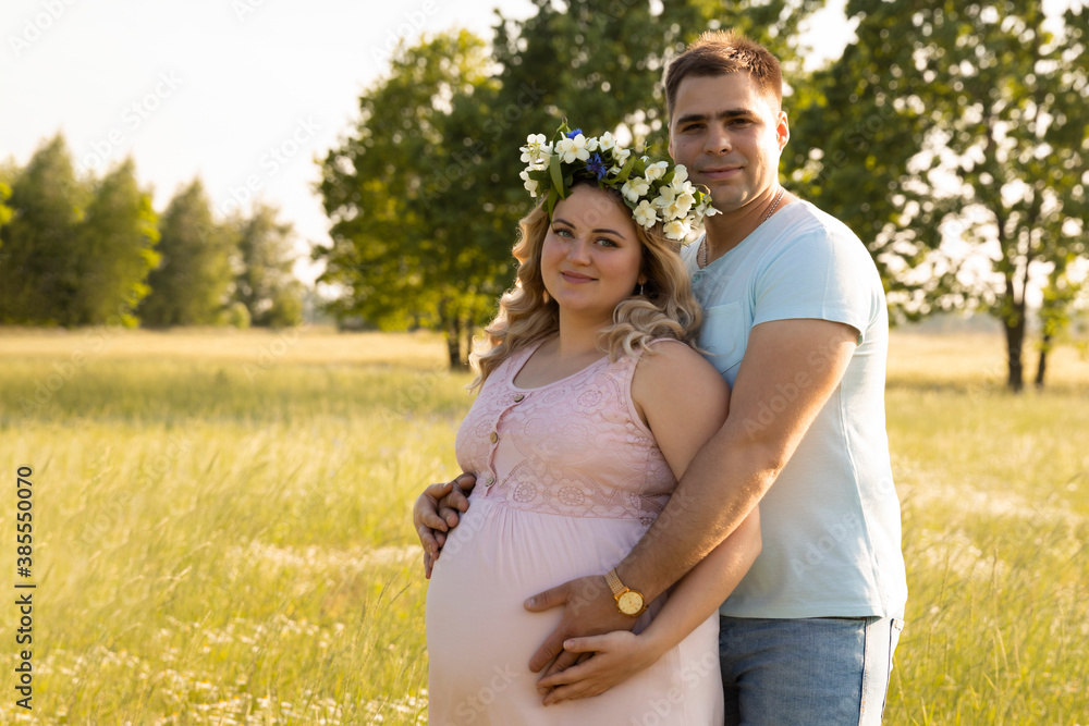 A pregnant woman with her husband is resting in nature. A pregnant woman with her husband is resting in nature.