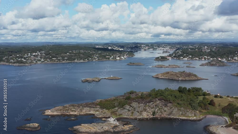 Aerial High Pan of seaside Arendal cityscape with white clouds, Norway Aerial High Pan of seaside Arendal cityscape with white clouds, Norway