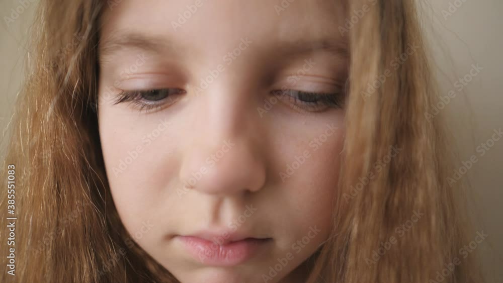 Close up female face of desperate child looking down indoor. Portrait of little blonde girl with sorrowful expression inside. Disappointed gaze of small upset kid Close up female face of desperate child looking down indoor. Portrait of little blonde girl with sorrowful expression inside. Disappointed gaze of small upset kid