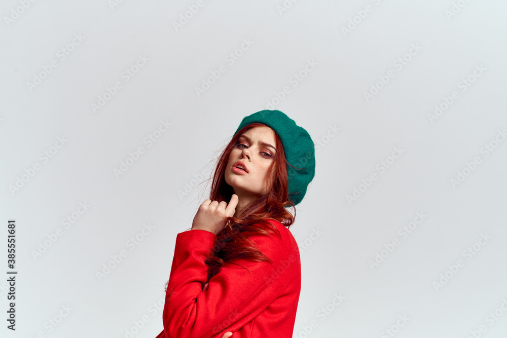 Woman in red coat and in green hat on isolated background cropped model with Copy Space emotions Woman in red coat and in green hat on isolated background cropped model with Copy Space emotions