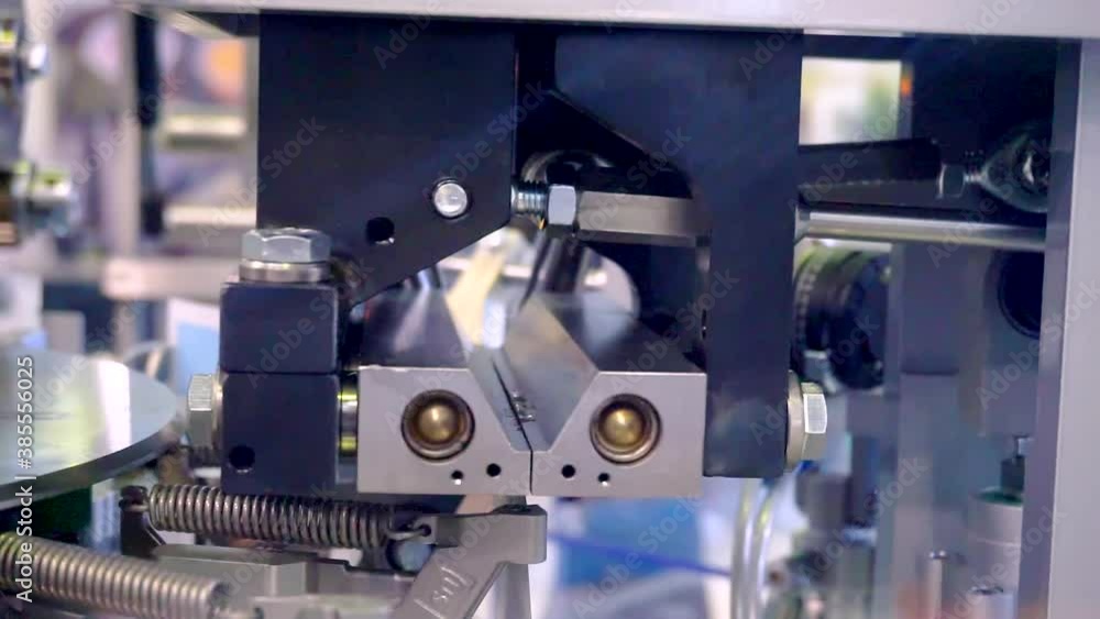 fragment of a working packaging machine. close-up. shallow depth of field. fragment of a working packaging machine. close-up. shallow depth of field.