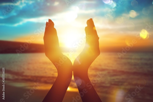 Female hands holding summer setting sun