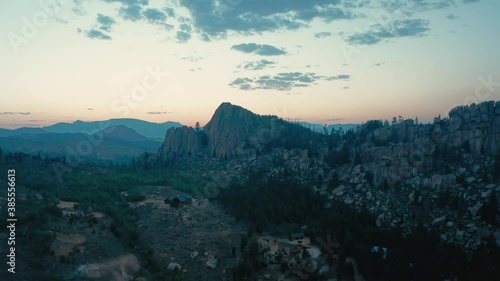 Drone pivots over mountain valley at dusk photo