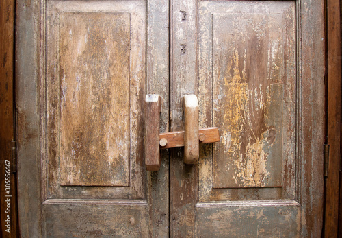 Closed old wood door with latch lock
