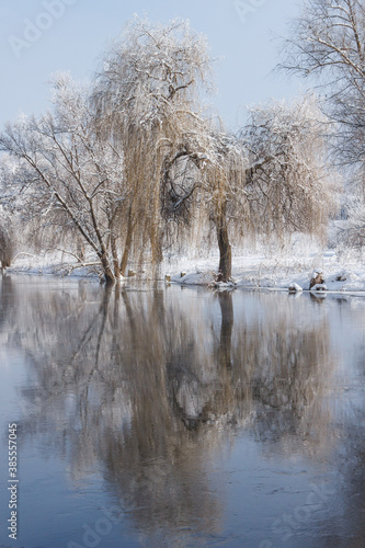 Winter river with snow-covered shores and trees. Winter landscape