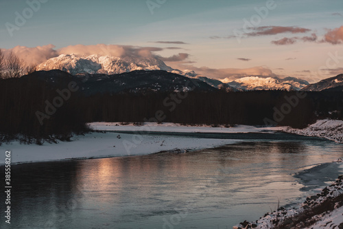 Distant snowy epic mountain near lake with nesting bald eagles.