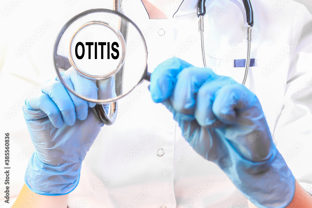 Doctor holding a card with text OTITIS, medical concept Doctor holding a card with text OTITIS, medical concept