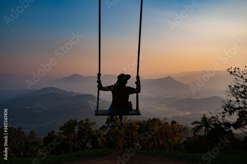 silhouette of a person on a swing