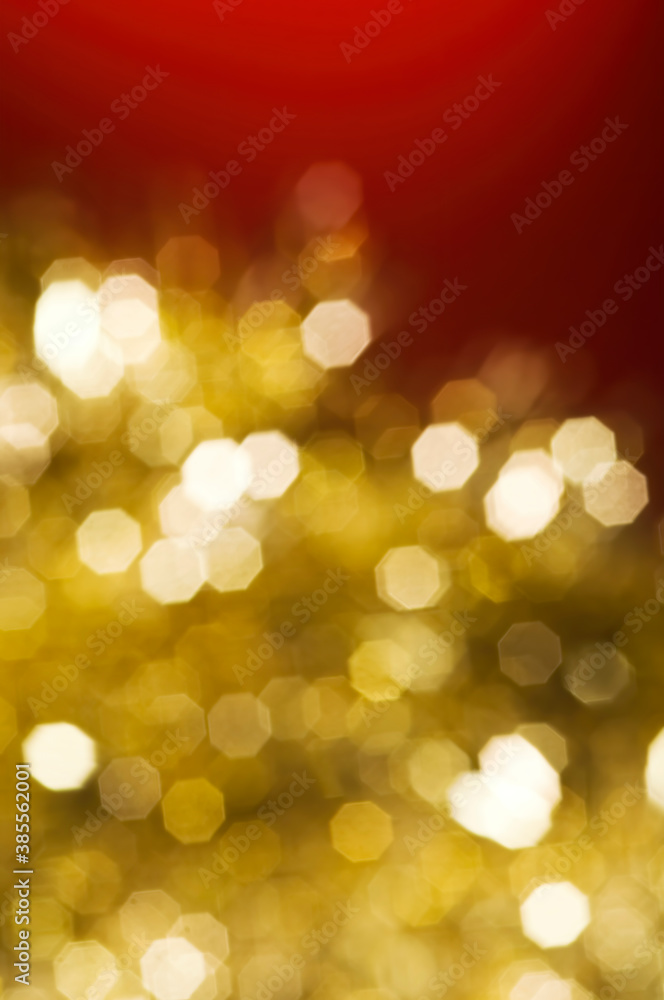 Christmas and New Year holidays blurred golden sparkles on red background, abstract background with bokeh defocused glittering lights and shadow Christmas and New Year holidays blurred golden sparkles on red background, abstract background with bokeh defocused glittering lights and shadow