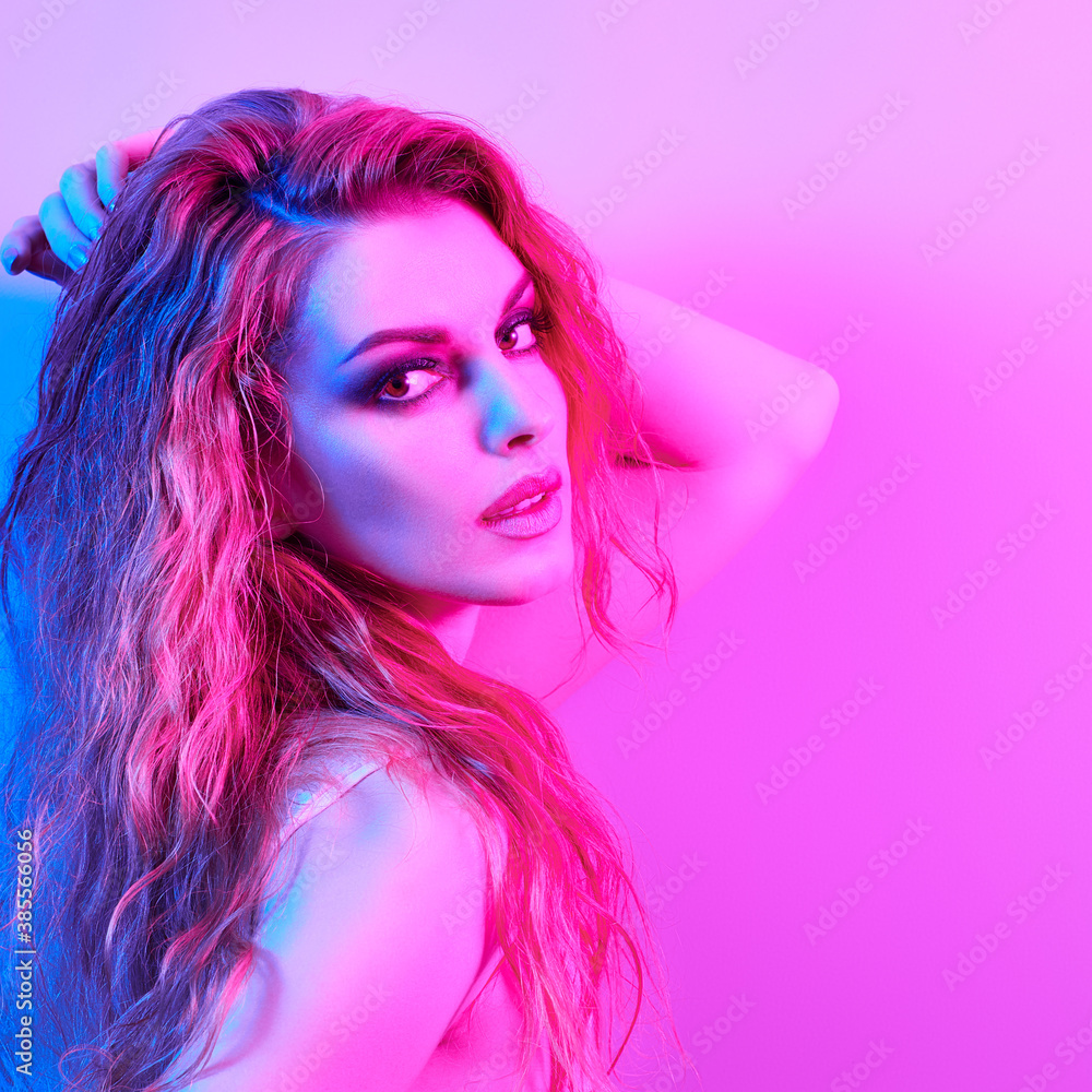 Naklejka premium High Fashion. Woman in colorful neon light, make-up. Sexy girl, stylish wet hair, trendy makeup. Party disco neon style. Creative art beauty portrait, fashionable model face, bright make up