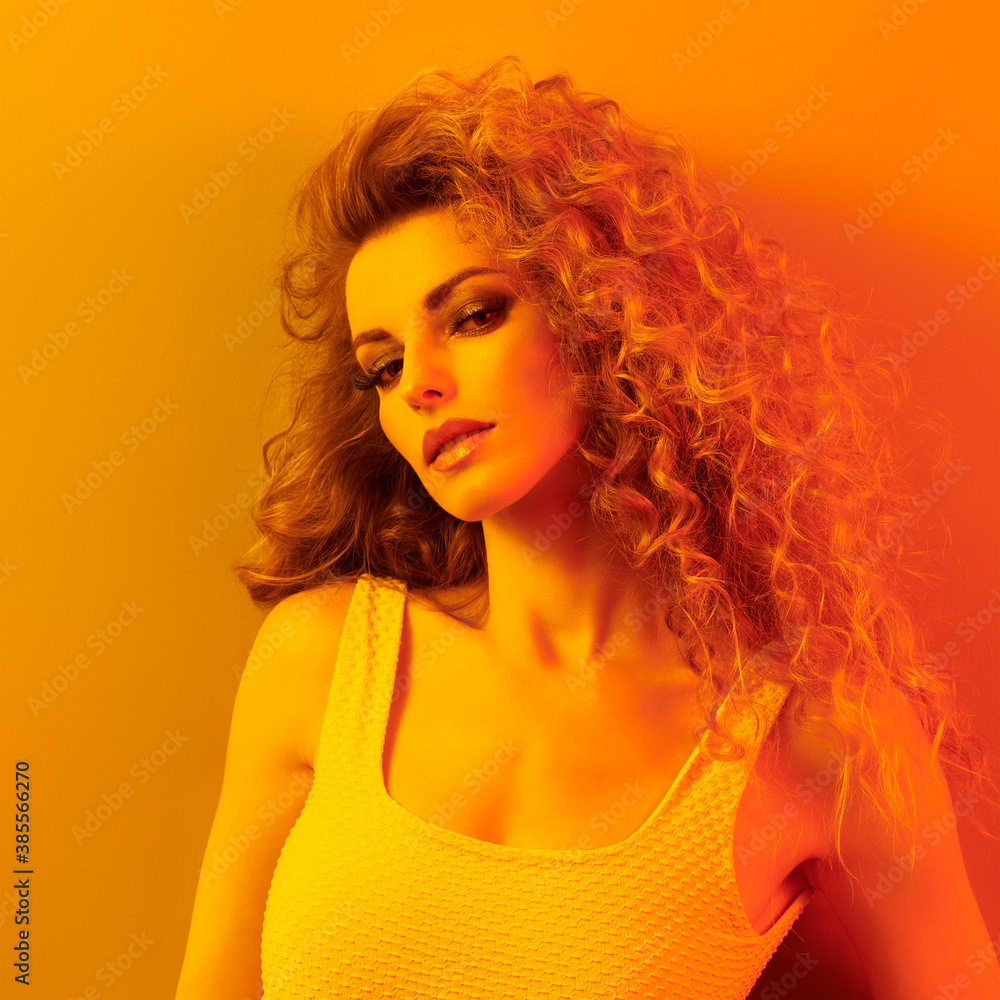 Woman in colorful neon gold light, Fashion make-up. Beautiful blond girl, stylish curly hair, trendy makeup. Creative beauty portrait, fashionable model, voluminous hairstyle Woman in colorful neon gold light, Fashion make-up. Beautiful blond girl, stylish curly hair, trendy makeup. Creative beauty portrait, fashionable model, voluminous hairstyle
