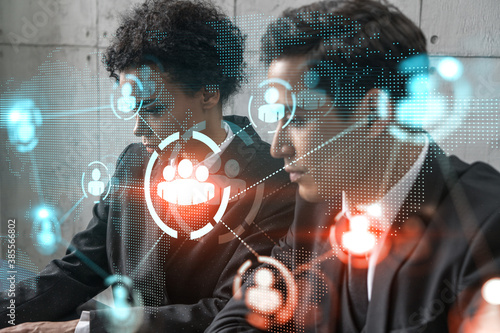 Two good looking businesspeople working on social network security project. Multiexposure. Hologram.