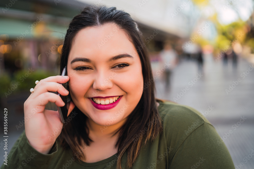 Young plus size woman talking on the phone. Young plus size woman talking on the phone.