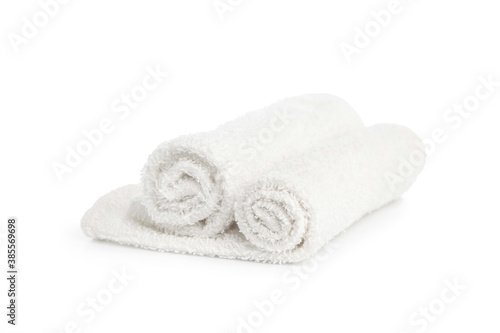 stack of white clean towels rolled up on white background