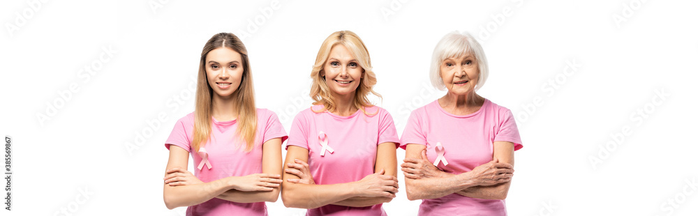 Horizontal image of women in pink t-shirts with breast cancer awareness ribbons looking at camera isolated on white Horizontal image of women in pink t-shirts with breast cancer awareness ribbons looking at camera isolated on white