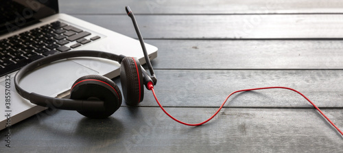 Headset on black background. Call center, home office, customer service support, help desk photo