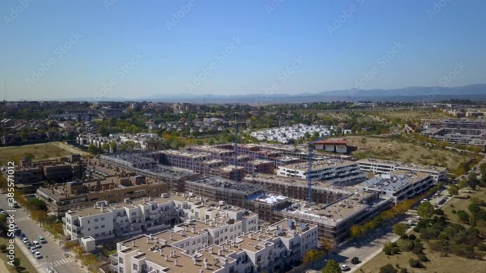 different aerial shots of cranes working on the construction of a new residential neighborhood under construction different aerial shots of cranes working on the construction of a new residential neighborhood under construction