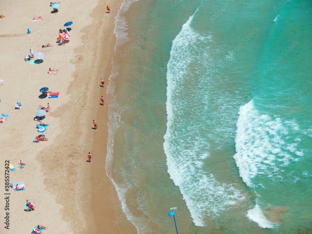 sandy beach, waves and the sea from above