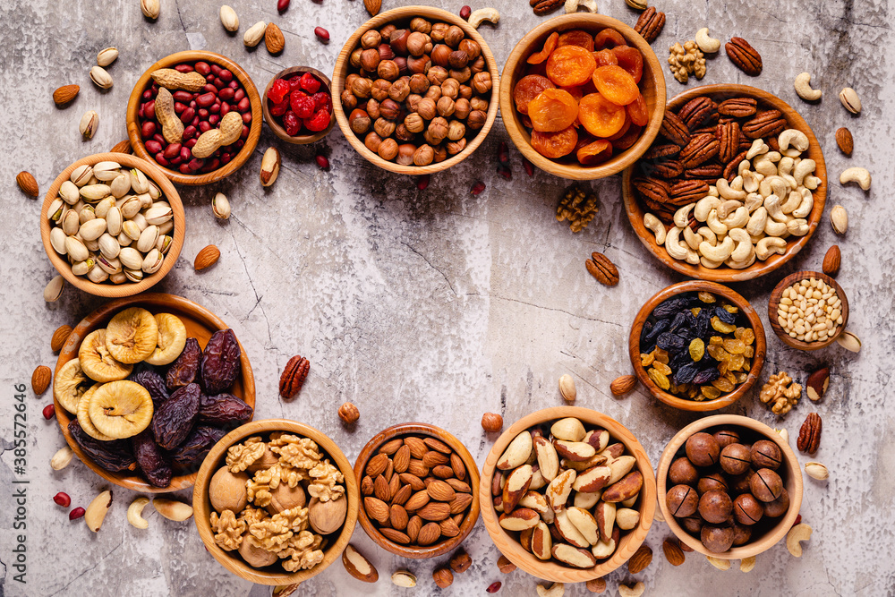 Various Nuts and dried fruits in wooden bowls.