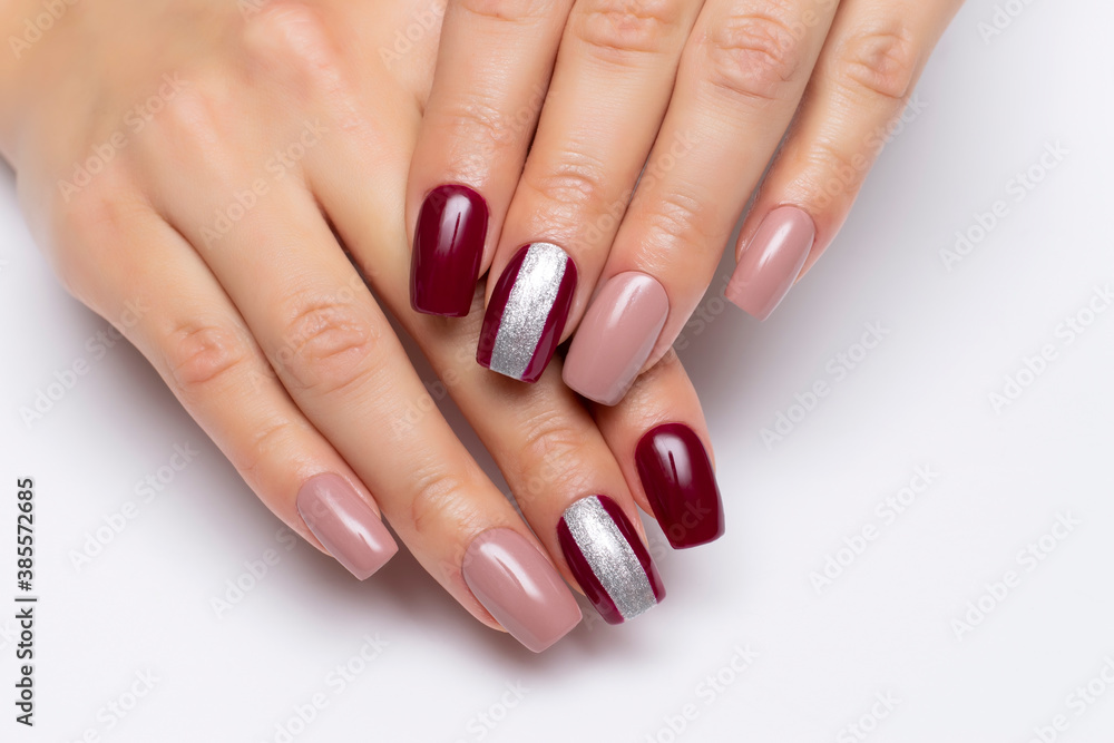 Gel manicure. Beige and burgundy manicure with a wide silver strip on long  square nails close-up on a white background. Stock Photo | Adobe Stock