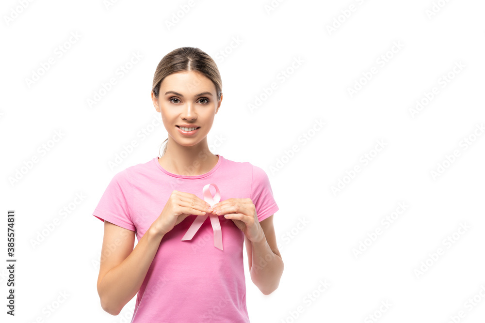 Young woman in pink t-shirt holding breast cancer awareness ribbon isolated on white - obrazy, fototapety, plakaty 
