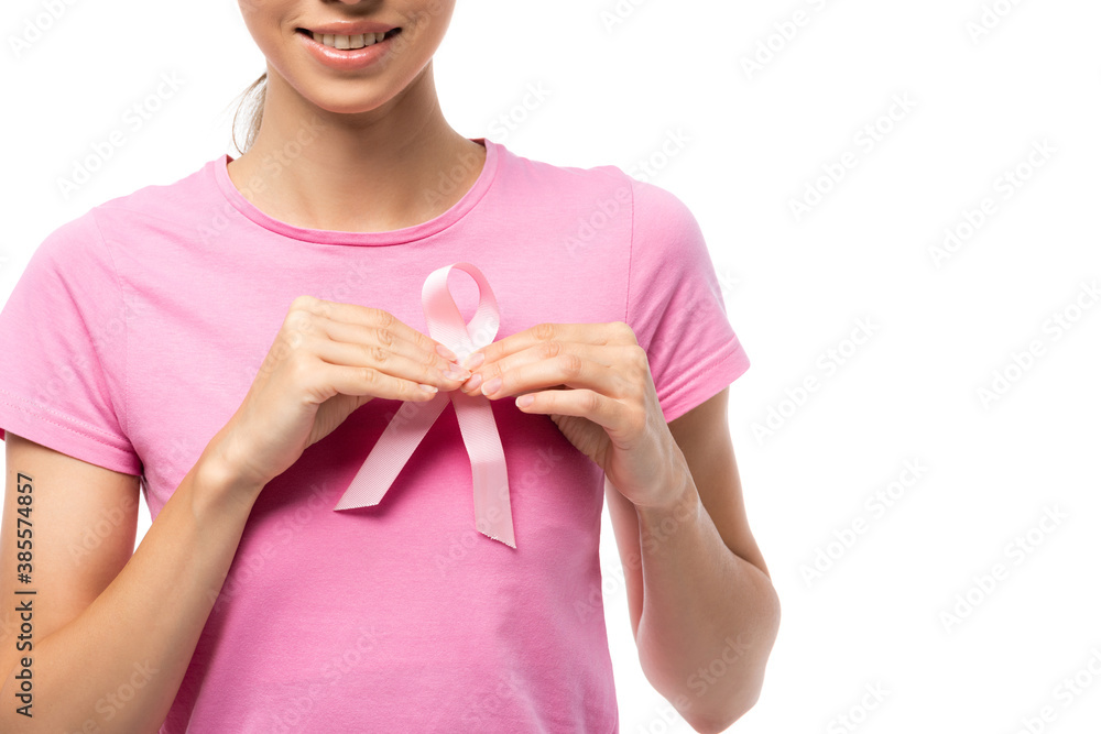 Cropped view of young woman holding breast cancer awareness ribbon isolated on white Cropped view of young woman holding breast cancer awareness ribbon isolated on white
