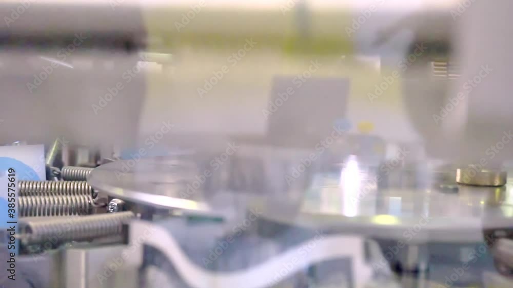 fragment of a working packaging machine. close-up. shallow depth of field.