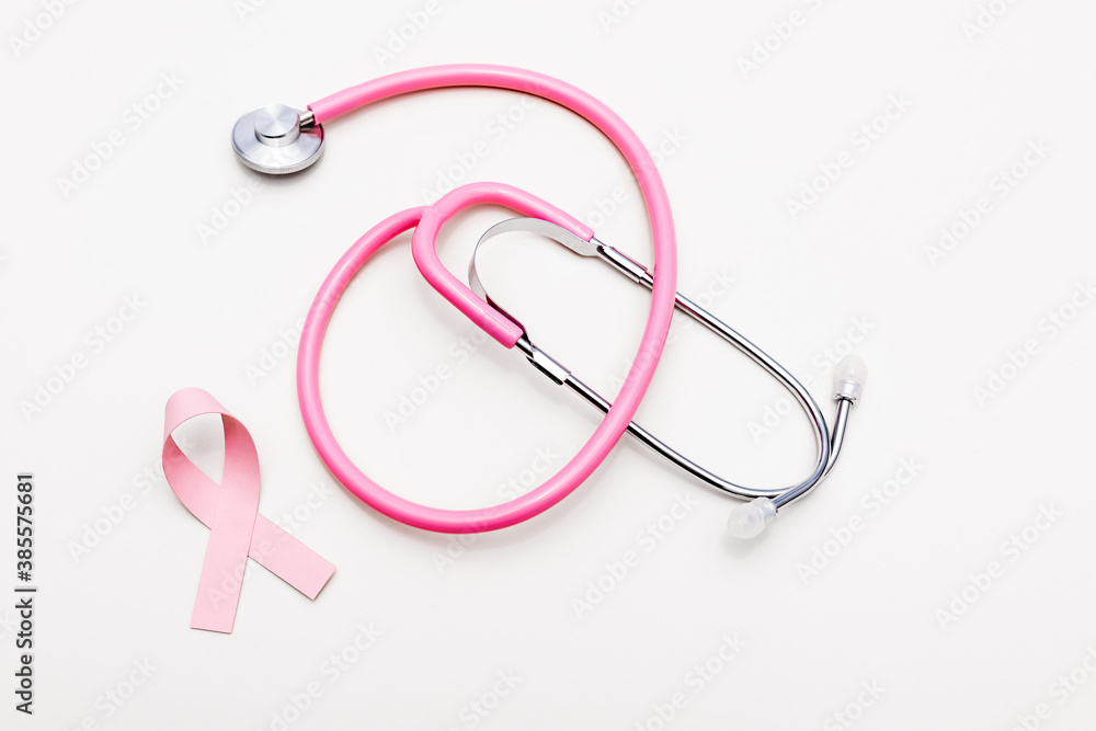 Top view of stethoscope and ribbon of breast cancer awareness isolated on white Top view of stethoscope and ribbon of breast cancer awareness isolated on white