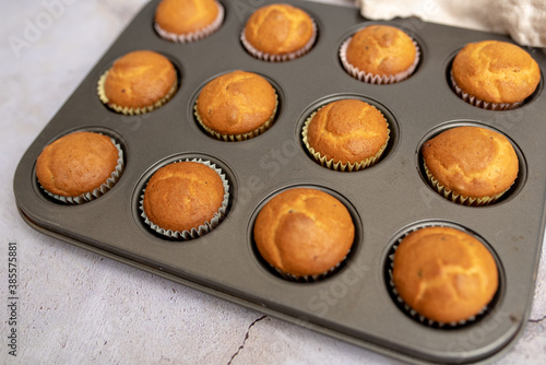 Mini muffins in paper cupcake holder and baking tray