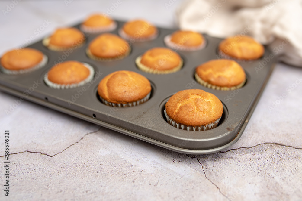 Mini muffins in paper cupcake holder and baking tray Mini muffins in paper cupcake holder and baking tray
