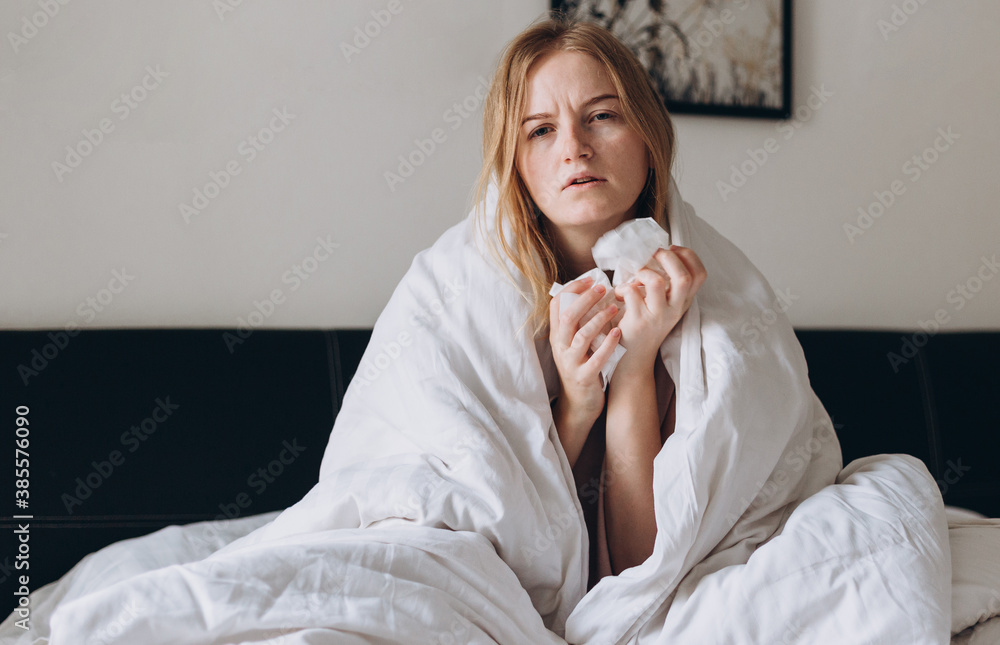 Sick girl of corona virus lying down in bed recovery from illness at home. Woman Caught Cold. Medicines concept, Sick woman with a headache Sick girl of corona virus lying down in bed recovery from illness at home. Woman Caught Cold. Medicines concept, Sick woman with a headache