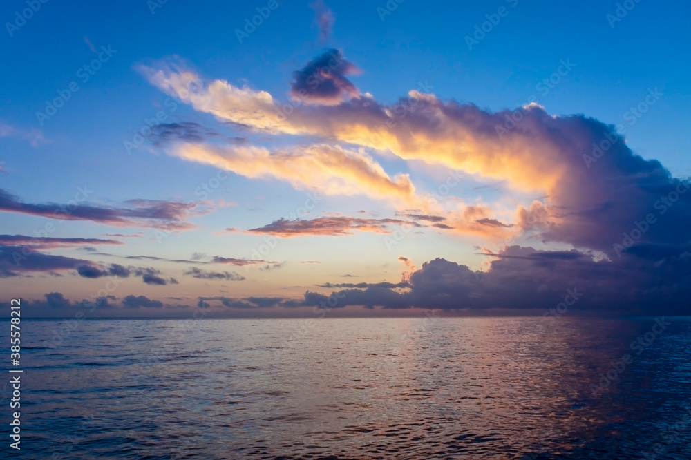 Landscape at sunset over the sea. Beautiful cloudy sky