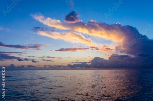 Landscape at sunset over the sea. Beautiful cloudy sky