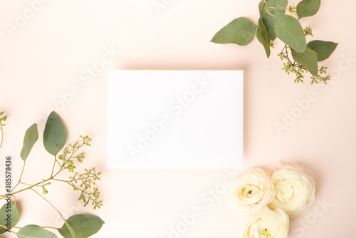 Fresh flower flat lay and blank card floral background with ranunculus and rose