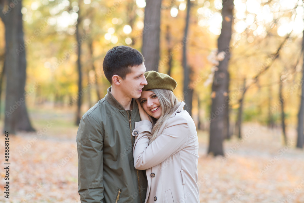 happy young couple embracing and spending time in the autumn outdoor. happy young couple embracing and spending time in the autumn outdoor.