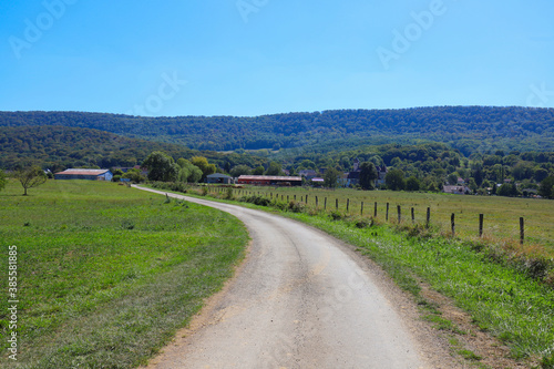 View of a french rural country road at summer on a sunny and warm day.
