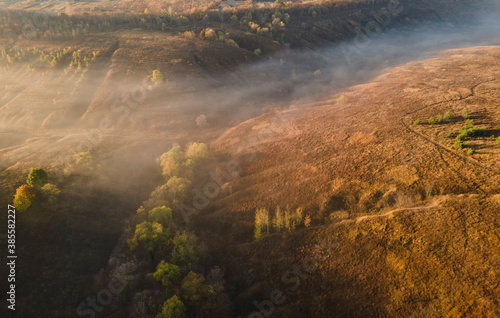 Aerial view to foggy valley autumn season