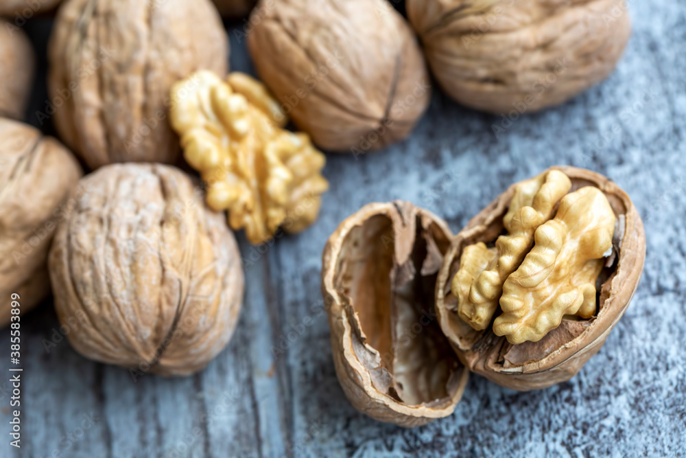 Ripe and raw whole big walnut kernel with thin shell on wooden rustic backdrop. Healthy nut food for brain. Fresh walnuts background concept Ripe and raw whole big walnut kernel with thin shell on wooden rustic backdrop. Healthy nut food for brain. Fresh walnuts background concept