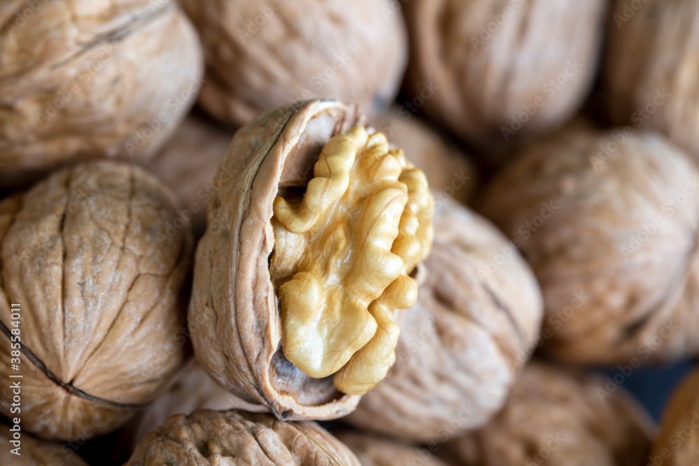 Ripe and raw whole big walnut kernel with thin shell on wooden rustic backdrop. Healthy nut food for brain. Fresh walnuts background concept Ripe and raw whole big walnut kernel with thin shell on wooden rustic backdrop. Healthy nut food for brain. Fresh walnuts background concept